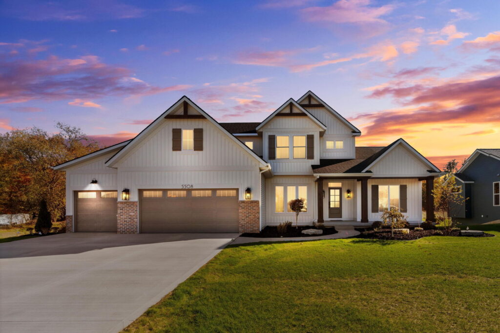 Front porch of white modern farmhouse with wood columns