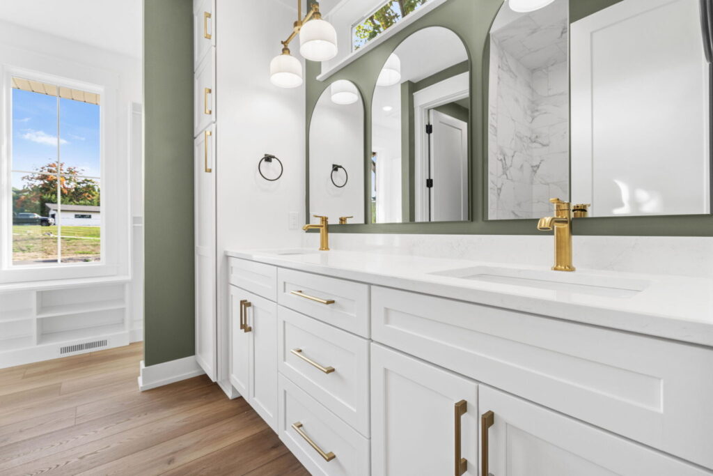 Bathroom vanity with white cabinets and brass fixtures
