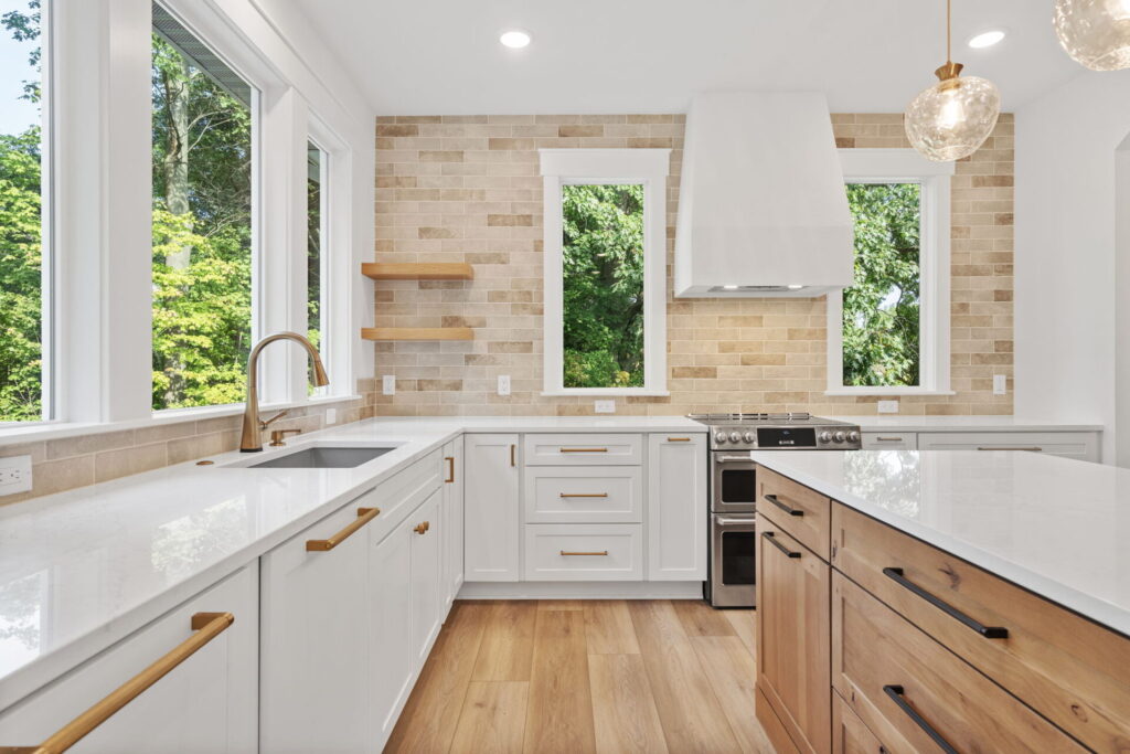 Bright kitchen with white cabinets and warm tile backsplash