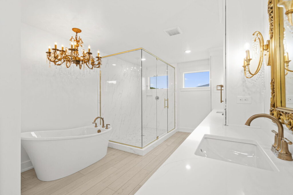 Luxury bathroom with freestanding tub and gold chandelier